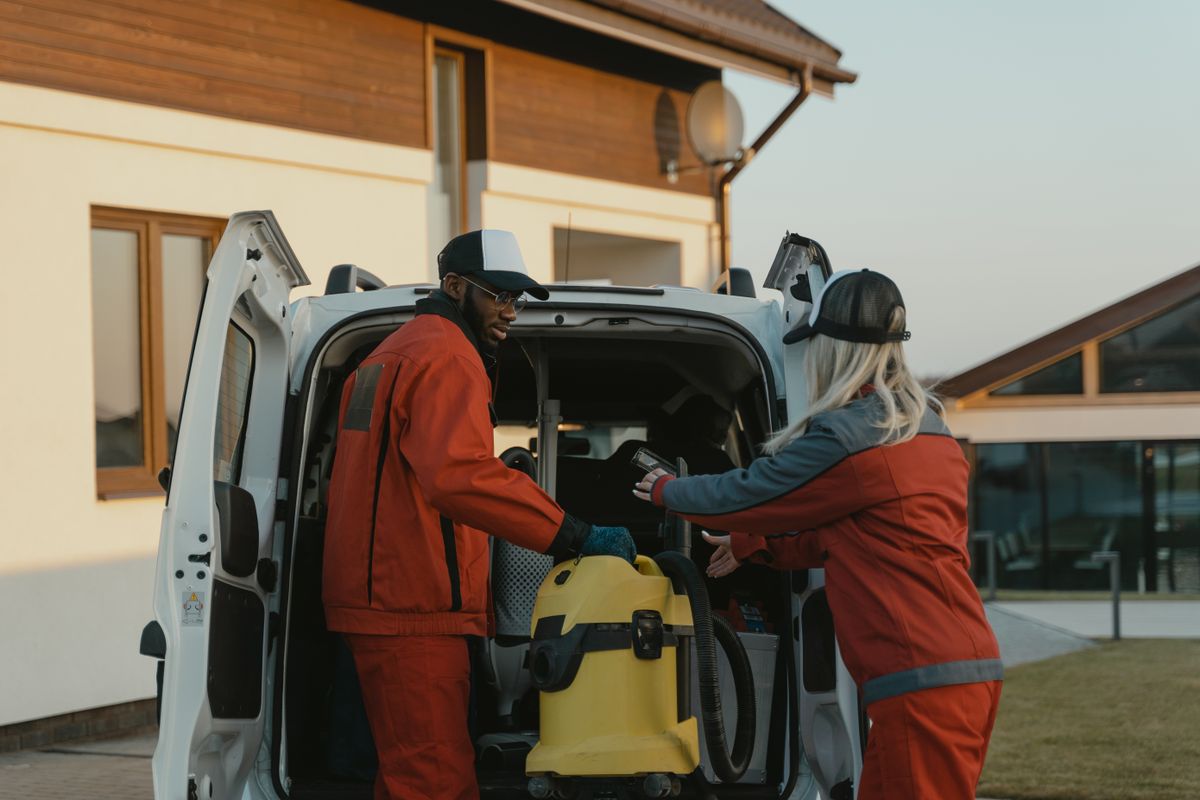 Cleaning team unloading professional equipment